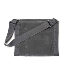 The Waxed Canvas Claymore Sling Bag is a flat, dark gray bag with an adjustable strap, displayed against a white background.
