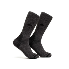 A pair of Merino Compression Socks in dark gray, featuring graduated compression, stand upright on a white background.