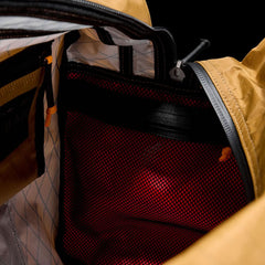 Close-up of the Kit Bag - X-PAC’s interior, showcasing a red mesh pocket and yellow fabric lining made from durable X-PAC VX21 material.