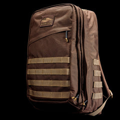 GR2 - Ballistic Nylon Cordura ruck in brown with tan MOLLE webbing, front patch, and zippered compartments—ideal for travel or as a carry-on. Shown against a black background.