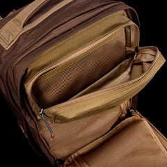 The GR2 - Ballistic Nylon Cordura, shown from above in brown, features multiple unzipped compartments and mesh pockets—making it a perfect carry-on compliant travel ruck.