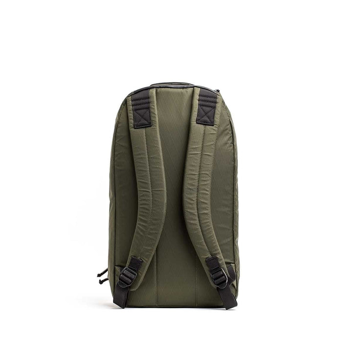 The Bullet X-PAC backpack in olive green is shown from the back, featuring padded straps, black accents, and durable AquaGuard zippers.