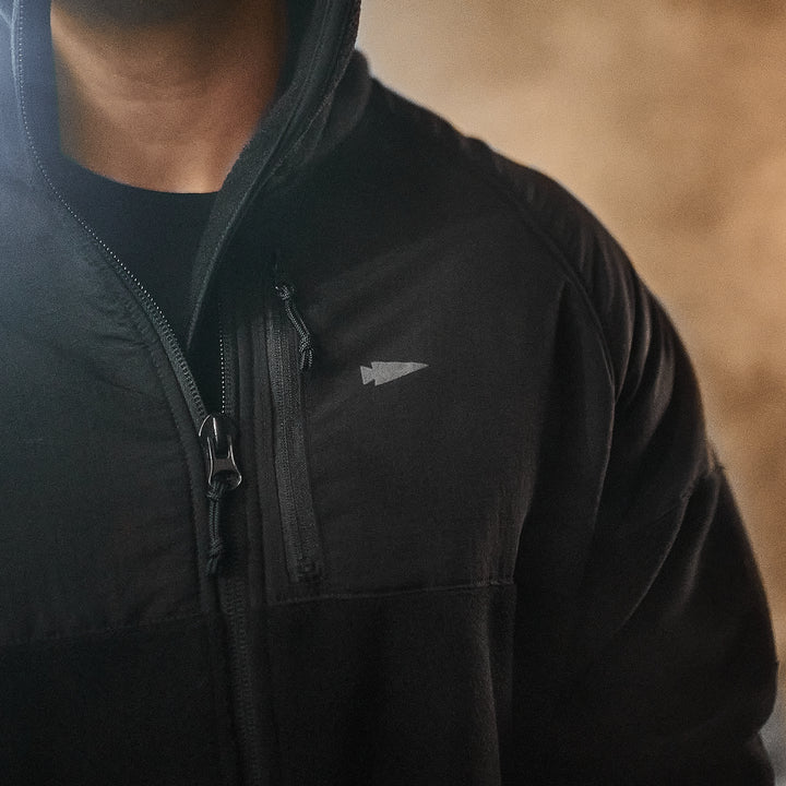 Wearing the Men’s Task Force Dagger Jacket - Polartec Fleece, with its small arrow logo on the chest, exudes an aura of mystery and precision reminiscent of Special Forces gear.