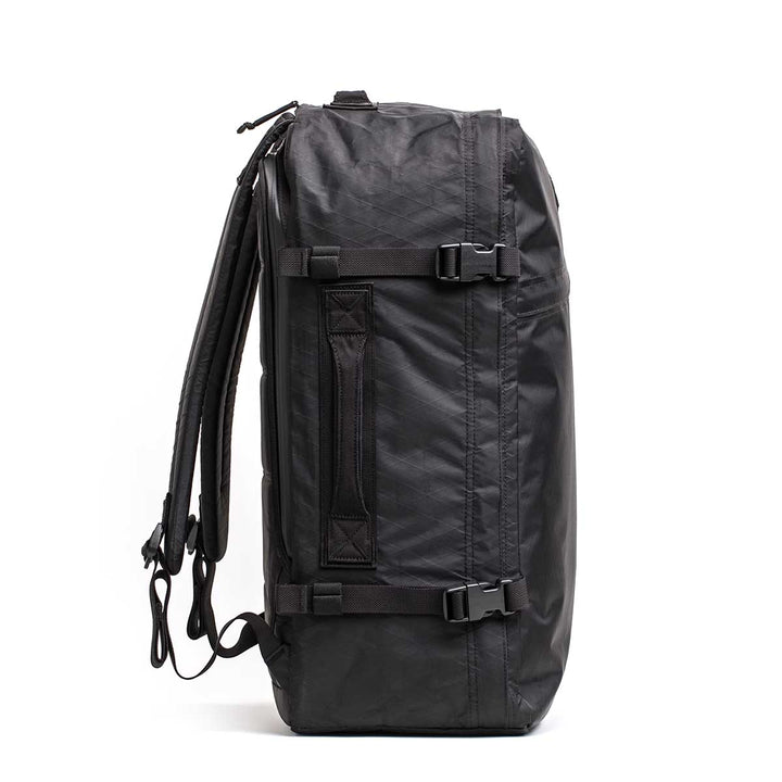 The GR3 - X-PAC is a black duffel bag with shoulder straps, side carry handle, and buckle details. Made from waterproof material, it works as a versatile carry-on backpack and is protected by the Scars Lifetime Guarantee.