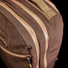 Close-up of brown 18LB Bullet Ruck backpack with beige zippers and heavy-duty fabric by GORUCK
