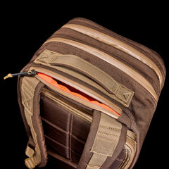 The Double Bullet Ruck w/ Bombproof Laptop Compartment - 18L features a brown design, tan zippers, padded straps, double compartments, and an open top revealing an orange interior.