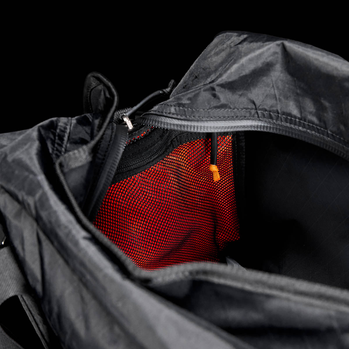 Open Kit Bag - X-PAC, featuring a visible red mesh pocket and an orange zipper pull, shown on a black background.