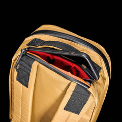GORUCK Bullet Ruck 15L backpack in coyote color with padded straps and smartphone in top pocket