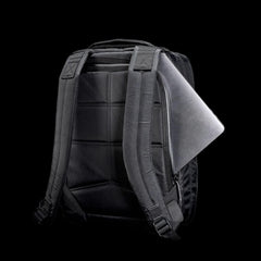 Black tactical GORUCK backpack with padded straps and back, laptop partially inserted in side zipper pocket