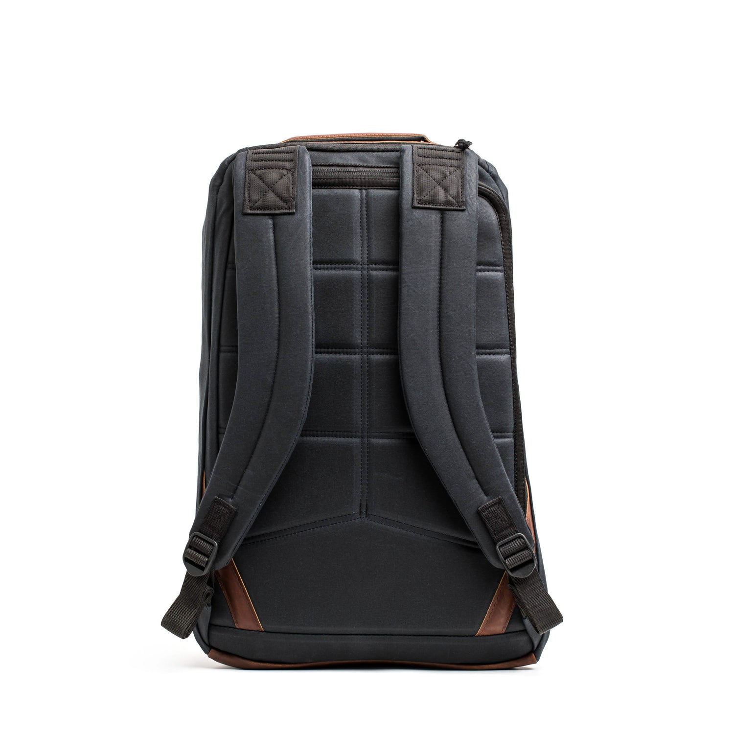 A front view of the GR1 USA - Heritage rucksack by GORUCK, showcasing a black design with brown accents, including padded straps and a quilted back panel. Made from waxed duck canvas, it stands upright against a white background, offering a blend of retro charm and modern functionality.