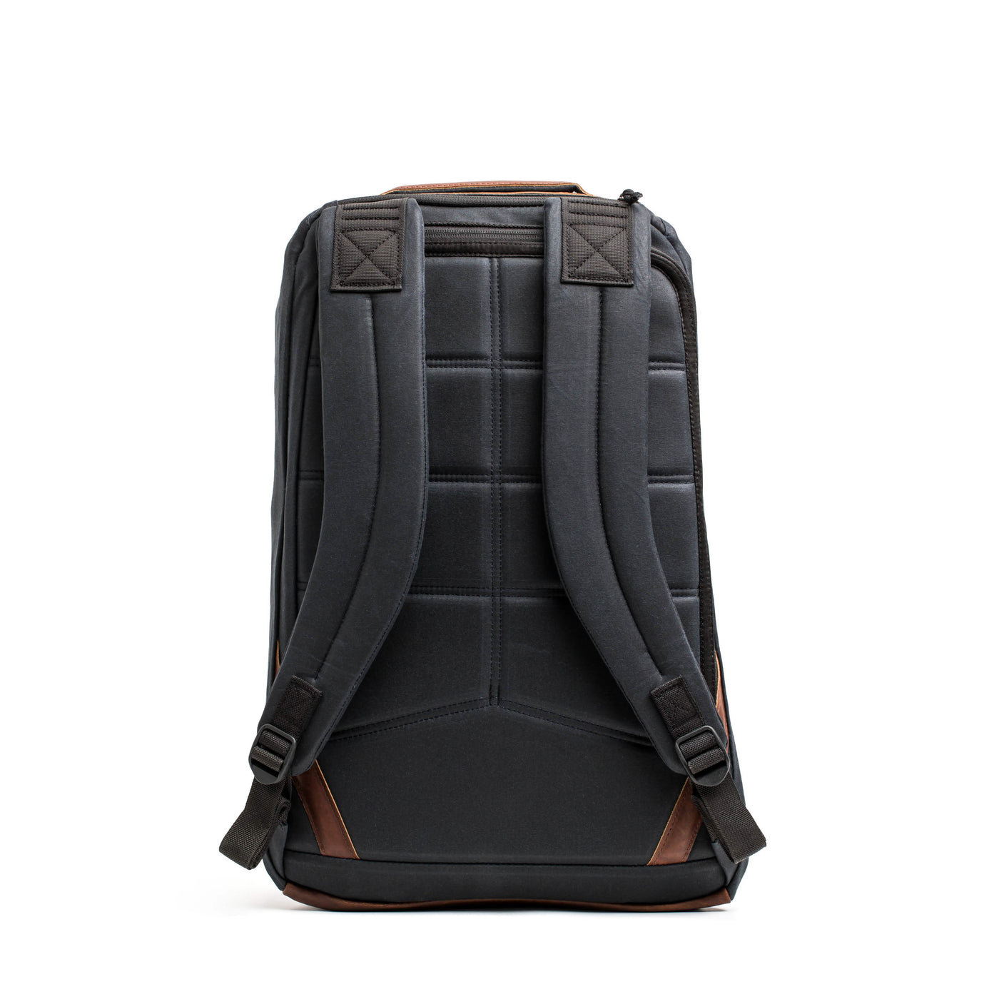 A front view of the GR1 USA - Heritage rucksack by GORUCK, showcasing a black design with brown accents, including padded straps and a quilted back panel. Made from waxed duck canvas, it stands upright against a white background, offering a blend of retro charm and modern functionality.