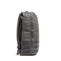 Side view of the gray GR1 USA - Cordura rucksack, built to Special Forces grade standards, with multiple loops and padded shoulder straps on a white background.