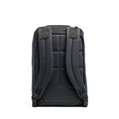 The GORUCK GR1 USA - Heritage in black is displayed from the back, showcasing its padded shoulder straps and stitched design on the back panel for enhanced comfort and support. The top features a zipper opening, merging classic style with modern functionality.