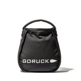The black Sand Kettlebells by GORUCK, shown with a handle on a white background, are ideal as portable kettlebells for at-home training.