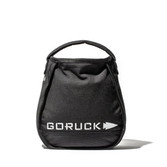 The black Sand Kettlebells by GORUCK, shown with a handle on a white background, are ideal as portable kettlebells for at-home training.