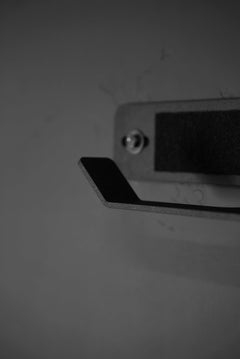 Close-up of the Ruck Rack® Delta—Heavy-Duty Wall Mount Storage for rucks, weight vests, and tactical gear—securely mounted on a flat surface with a screw visible above the sturdy hook, perfect for organizing tactical equipment or storing plate carriers.