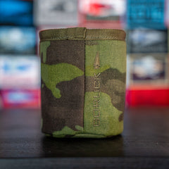 The Ballistic Beer Jacket features a camouflage pattern with a vertical arrow and "GORUCK" logo, displayed against a colorful blurred background.