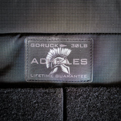 Close-up of the "GORUCK 30LB ACHILLES LIFETIME GUARANTEE" patch with a Spartan helmet on the Achilles | Men's Weighted Vest.