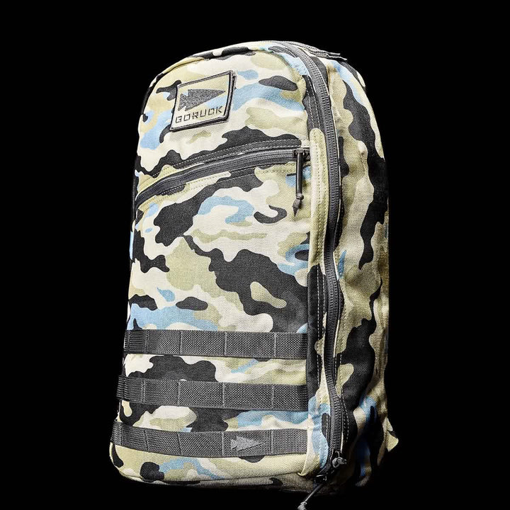 The Bullet Ruck Classic - Cordura by GORUCK boasts a streamlined camouflage design with the logo prominently displayed on the top left over a sleek black background, and is equipped with padded straps for added comfort.