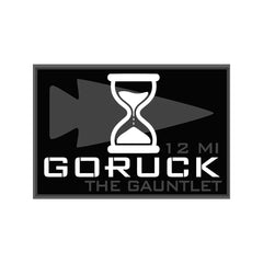 GORUCK The Gauntlet 12 mile patch with hourglass and arrowhead logo, black background.