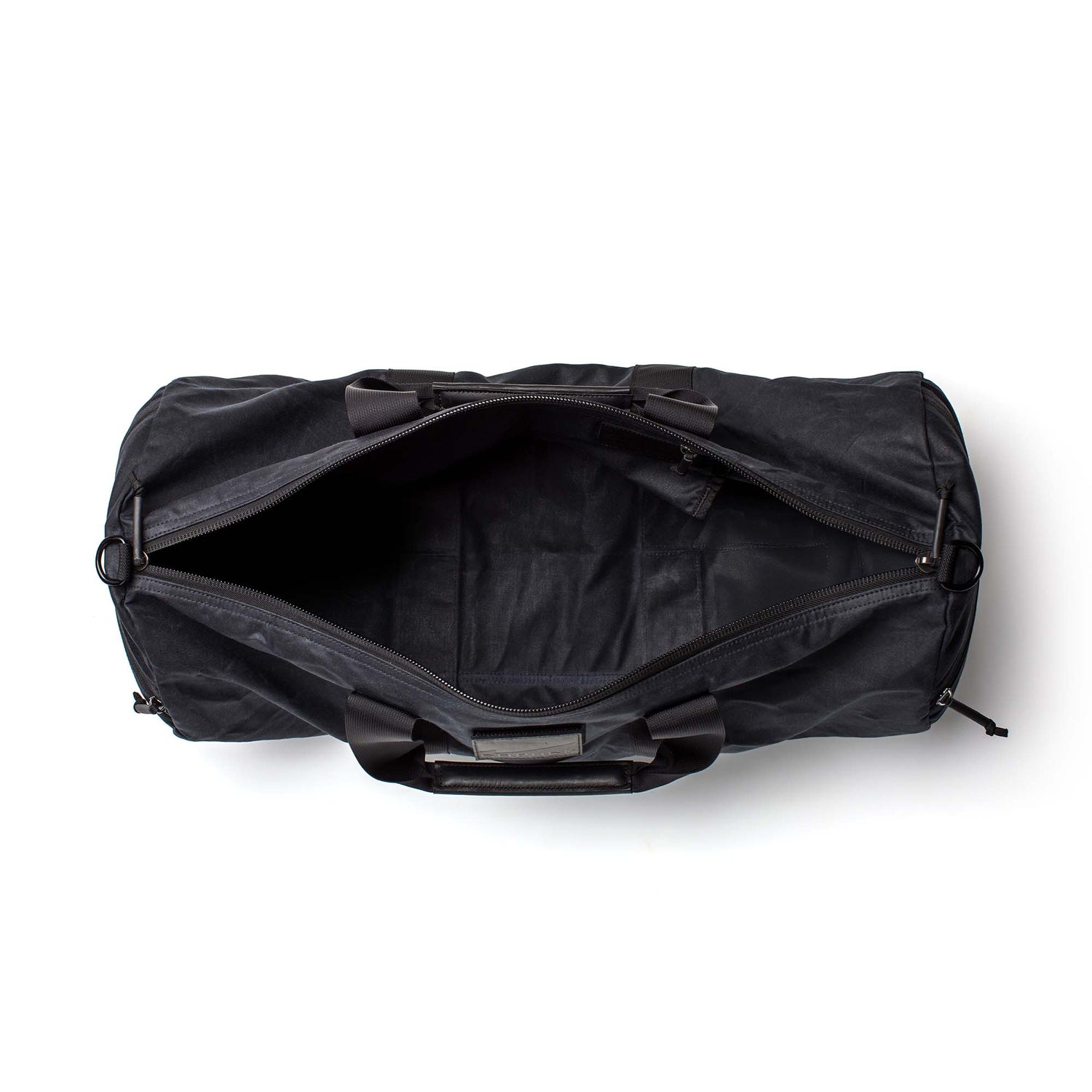 Black Gym Bag - Waxed Canvas, 38L, shown from above with open zipper revealing empty interior on a white background.