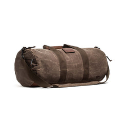 Gym Bag - Waxed Canvas with dark straps and a shoulder strap, displayed on a white background.