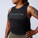 GORUCK women's sleeveless black tank top with logo, worn by model with arm tattoos