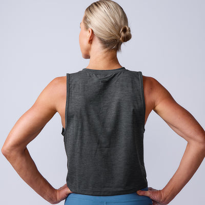 A blonde woman with her hair in a bun is seen from the back wearing a sleeveless dark gray Women’s USA Performance Tank - ToughMesh, made in Italy.