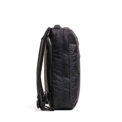 Side view of a black GORUCK durable rucksack with padded shoulder straps on white background
