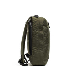 Side view of a dark green rugged GORUCK backpack with padded straps and diamond stitching
