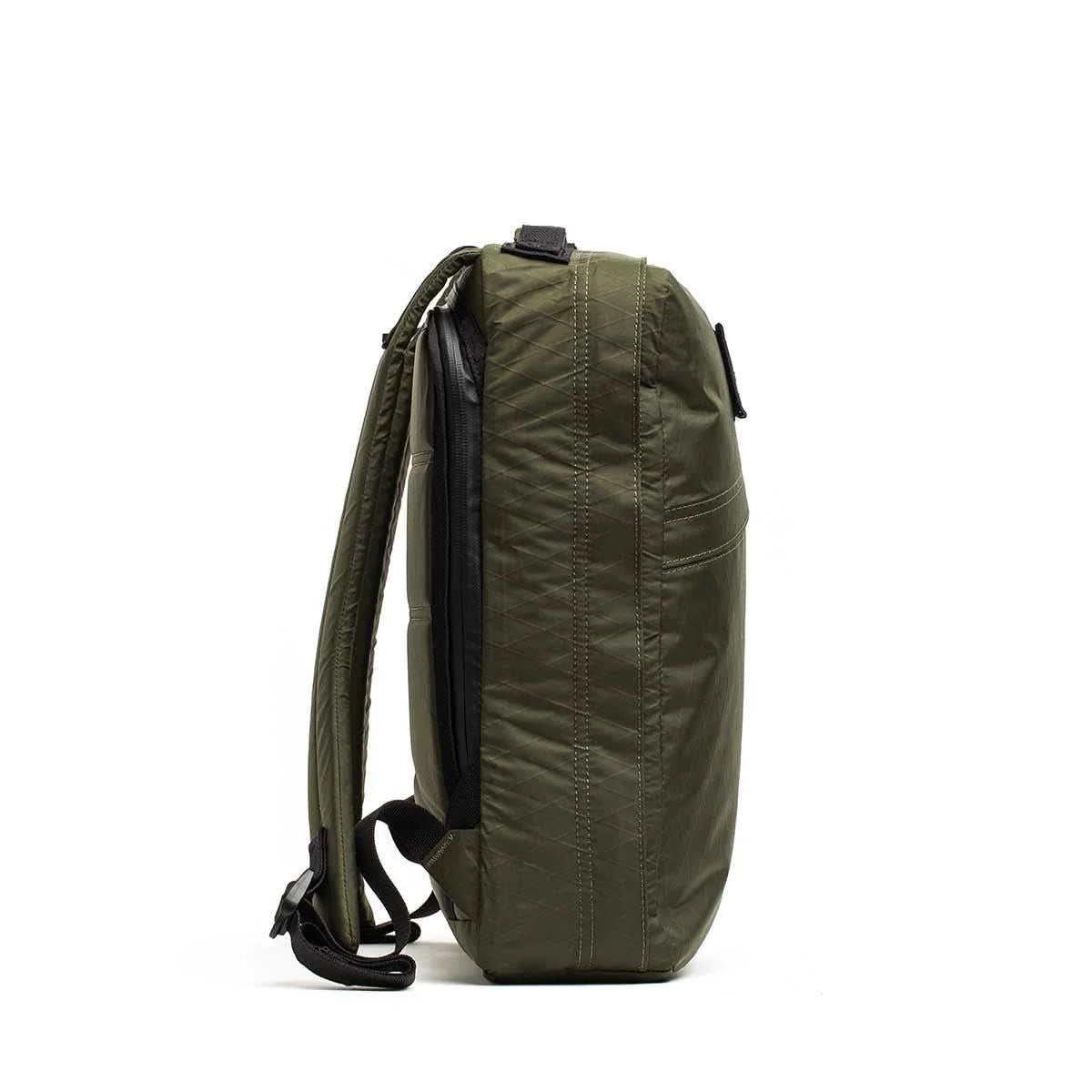Side view of the GR0 - X-PAC, an olive green waterproof rucksack with black zippers and adjustable shoulder straps, made from X-PAC fabric, shown against a white background.