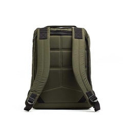 The GR0 - X-PAC backpack in olive green is shown from the back, featuring padded shoulder straps, quilted padding, and a bombproof laptop compartment.