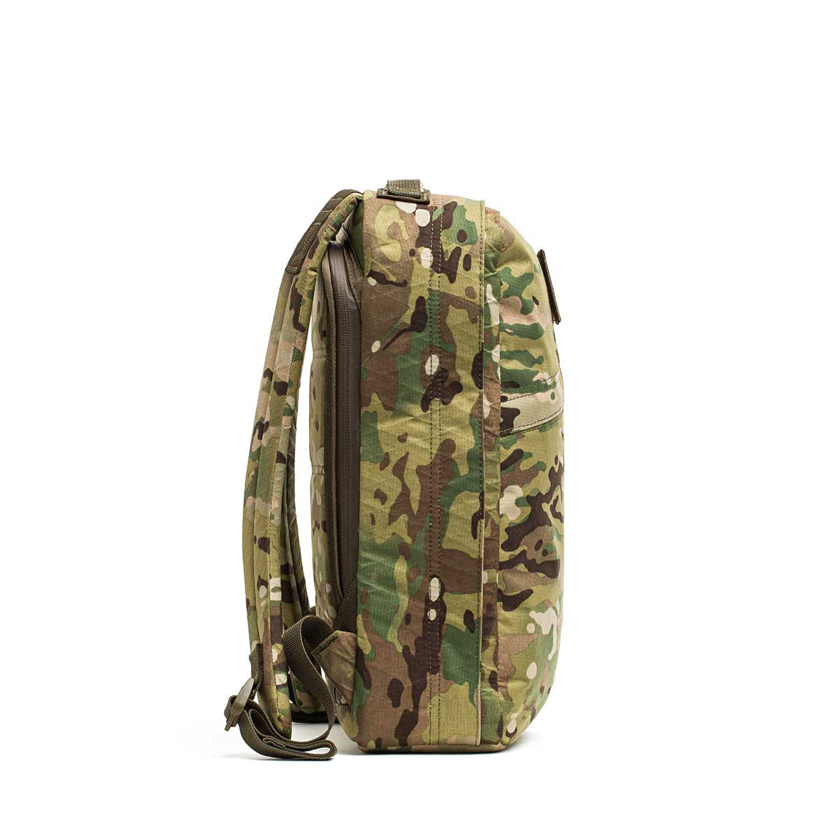 Side view of the GR0 - X-PAC, a lightweight, waterproof rucksack in a camouflage pattern with two shoulder straps, displayed on a white background.