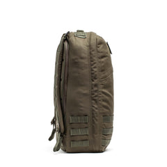Side view of the GR1 USA - Cordura in olive green, a Special Forces grade tactical backpack with straps and MOLLE webbing for everyday carry, shown on a white background.