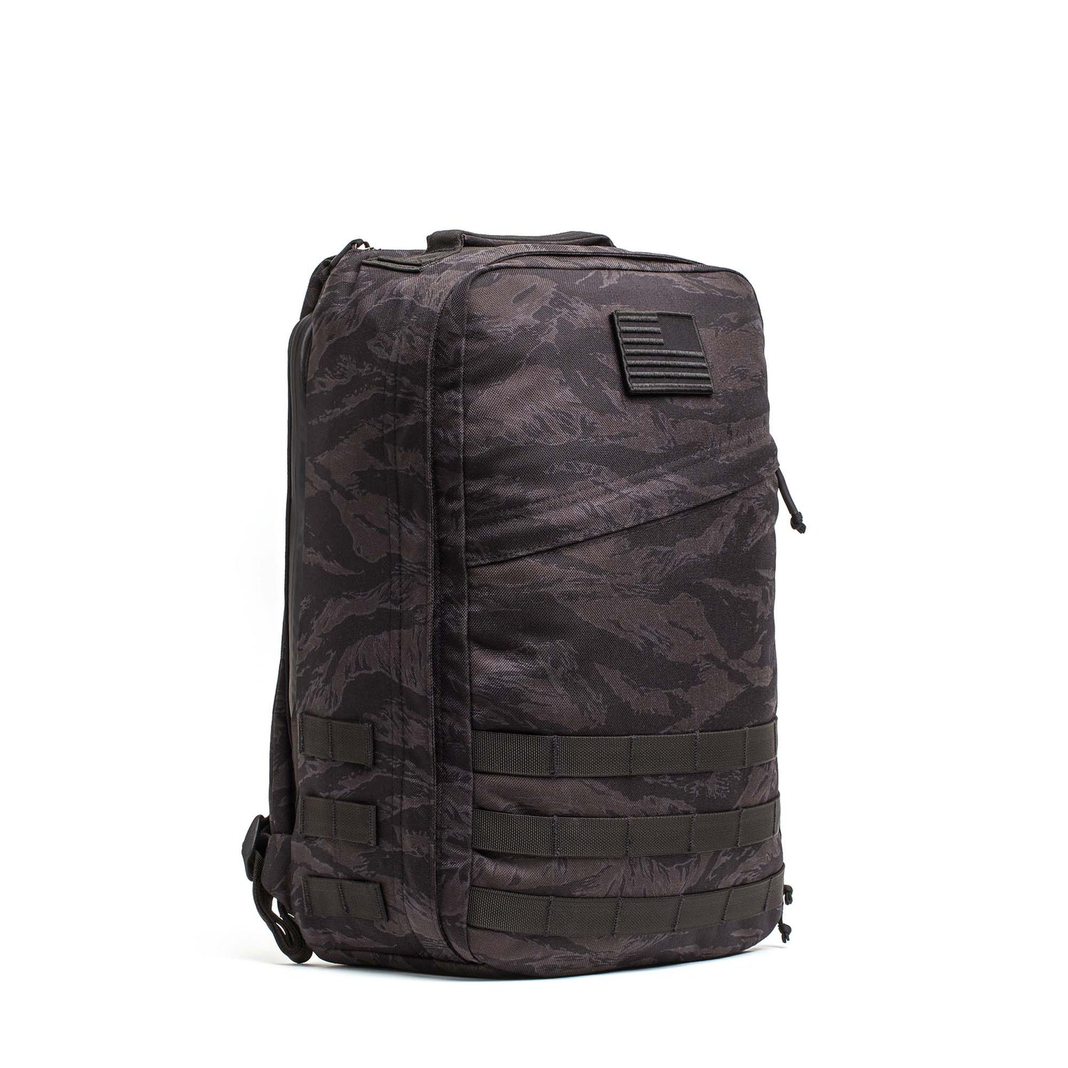 The GR1 USA - Cordura is a black and gray camouflage everyday carry rucksack, featuring a front zipper pocket and Special Forces grade webbing on the lower half, inspired by GORUCK Challenge designs.