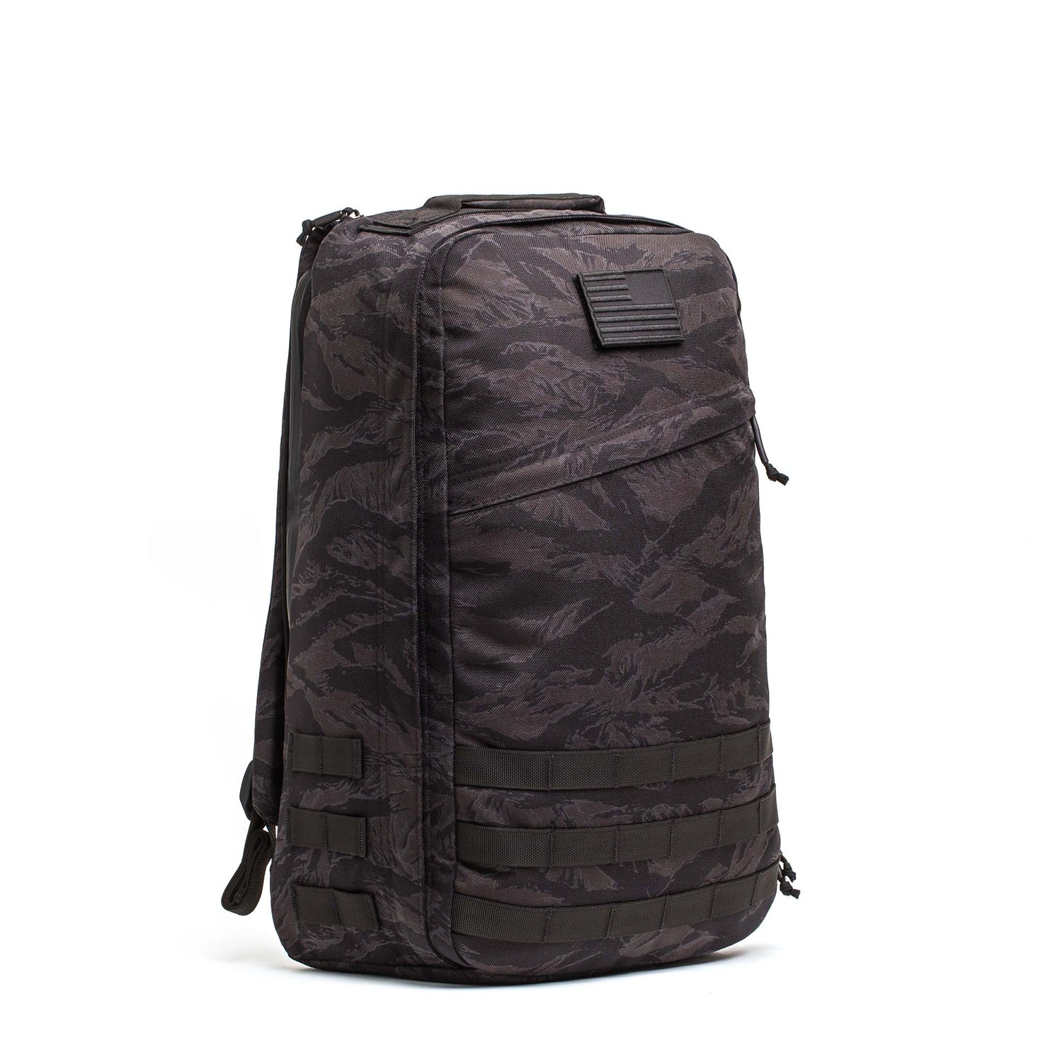 The GR1 USA - Cordura is a black and grey camo rucksack with a front zipper pocket and horizontal straps, designed for everyday carry and built to Special Forces standards.