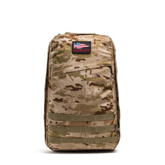 The GR1 USA - Cordura is a camouflage rucksack featuring a small American flag patch and "GORUCK" branding, built to Special Forces standards for the ultimate everyday carry backpack.