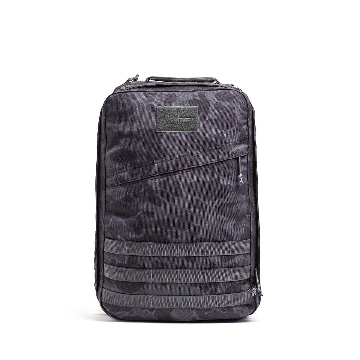 The GR1 rucksack features a black and gray camouflage pattern with a front zipper pocket, shown on a white background. Built to Special Forces grade, it's ideal for everyday carry.