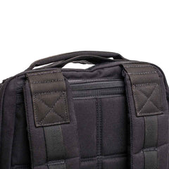 Close-up of black GORUCK backpack shoulder straps and top handle made of durable fabric