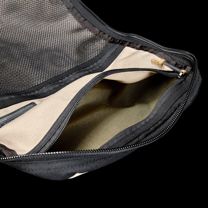 The GR1 Shooter 26L - Built by SCARS is a beige zippered CORDURA® pouch with black mesh and a visible zipper pocket, designed tough for the SCARS team or any Shooter Ruck, shown against a black background.