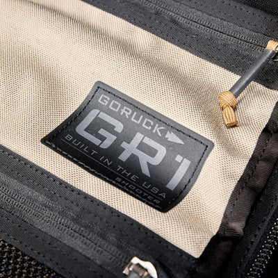 Close-up of a GR1 Shooter 26L - Built by SCARS label on beige CORDURA® fabric, displaying "Built in the USA"—a mark of durability and expert SCARS craftsmanship.