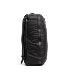 Side view of black GORUCK tactical rucksack with durable zippers and padded straps