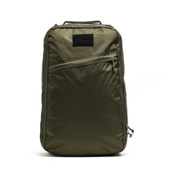 GORUCK dark green tactical backpack with diagonal zippered front pocket and top handle, rugged rucking gear