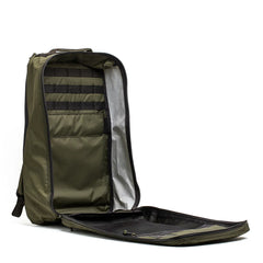Open dark green rugged rucksack with organized interior pockets and zippered mesh compartment by GORUCK