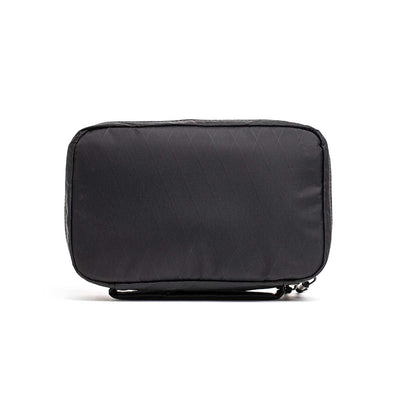 The GR1 Field Pocket - X-PAC is a rectangular black travel pouch with AquaGuard zippers, shown standing upright on a white background—ideal for organizing electronics.