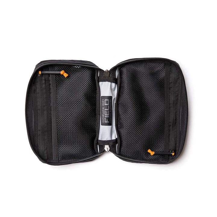 The GR1 Field Pocket - X-PAC is a black electronics organizer made from waterproof X-PAC fabric with AquaGuard zippers, mesh zippered pockets, and labeled inner sections, shown open on a white background.