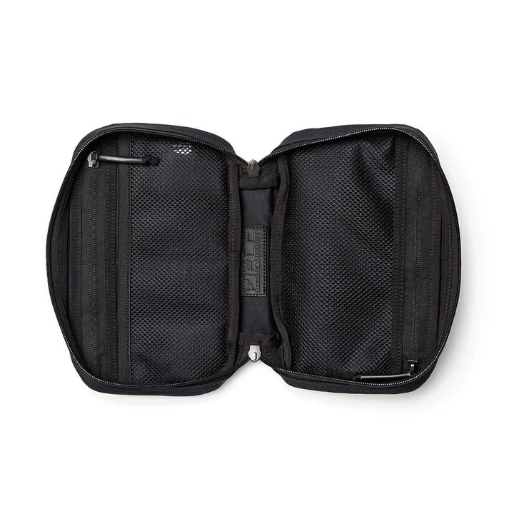 The GR1 Field Pocket - Waxed Canvas travel pouch is shown unzipped, revealing two mesh compartments and small interior pockets.
