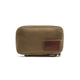 The GR1 Field Pocket - Waxed Canvas in small olive green features a front brown leather GORUCK patch made from Red Wing Leather, shown on a white background.