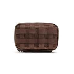 The GR1 Field Pocket is a small brown tactical pouch with front webbing, ideal for organizing electronics or attaching to gear and bags.