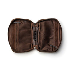 The GR1 Field Pocket, shown unzipped on a white background, reveals mesh and fabric compartments ideal for organizing electronics or keeping camera gear tidy.